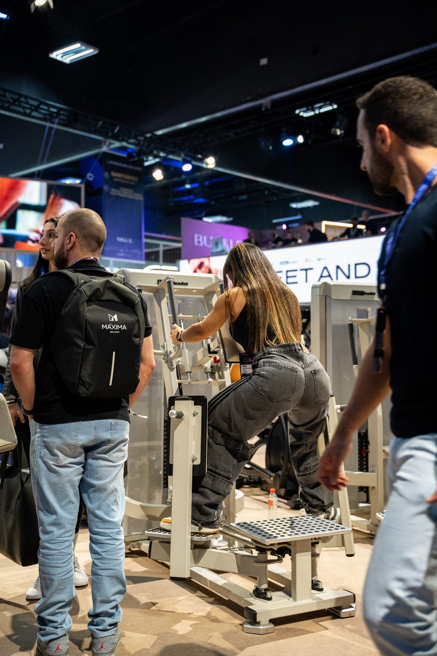 Athlete using the Gluteleader Standing Abductor GL-1005 at a fitness exhibition